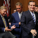 Lindsey Graham talks to Jeff Flake about his vote as they depart with Ted Cruz after the judiciary committee voted to move the nomination of Brett Kavanaugh forward to the full Senate.